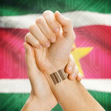 Barcode ID number on wrist and national flag on background - Suriname Barc... Stock Photos