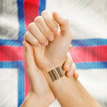 Barcode ID number on wrist and national flag on background - Faroe Islands... Stock Photos