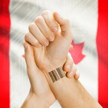 Barcode ID number on wrist and national flag on background - Canada Barcod... Stock Photos