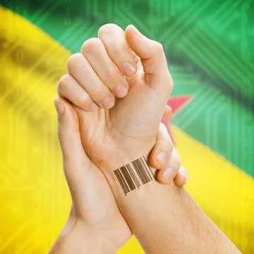 Barcode ID number on wrist and national flag on background - French Guiana... Stock Photos