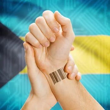 Barcode ID number on wrist and national flag on background - Bahamas Barco... Stock Photos
