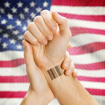 Barcode ID number on wrist and national flag on background - United States... Stock Photos
