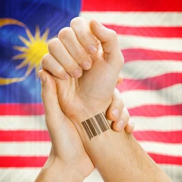 Barcode ID number on wrist and national flag on background - Malaysia Barc... Stock Photos