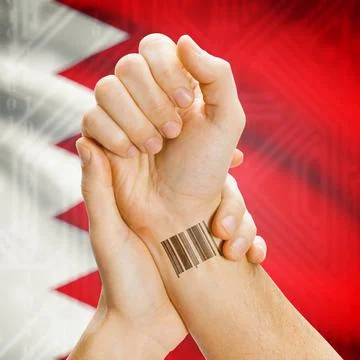 Barcode ID number on wrist and national flag on background - Bahrain Barco... Stock Photos