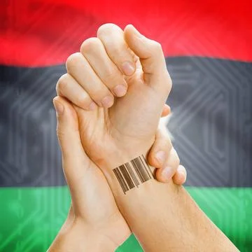 Barcode ID number on wrist and national flag on background - Libya Barcode... Stock Photos