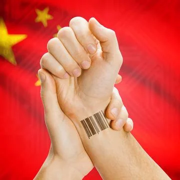 Barcode ID number on wrist and national flag on background - China Barcode... Stock Photos