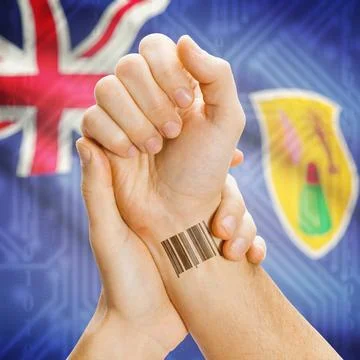 Barcode ID number on wrist and national flag on background - Turks and Cai... Stock Photos