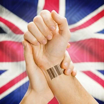 Barcode ID number on wrist and national flag on background - United Kingdo... Stock Photos