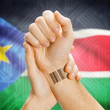 Barcode ID number on wrist and national flag on background - South Sudan B... Stockfoto's