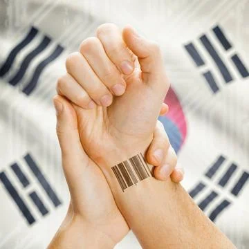Barcode ID number on wrist and national flag on background - South Korea B... Stock Photos