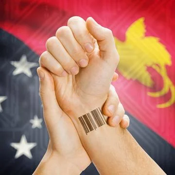 Barcode ID number on wrist and national flag on background - Papua New Gui... Stock Photos