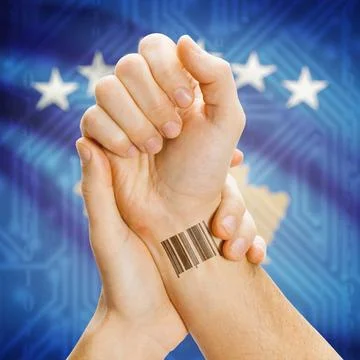 Barcode ID number on wrist and national flag on background - Kosovo Barcod... Stock Photos