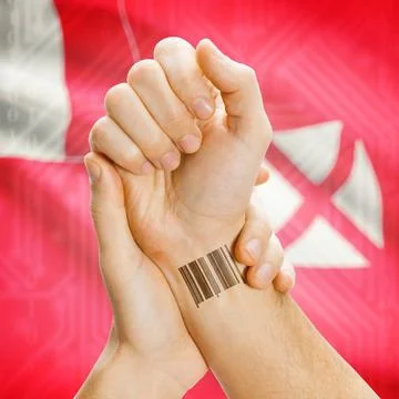 Barcode ID number on wrist and national flag on background - Wallis and Fu... Stock Photos