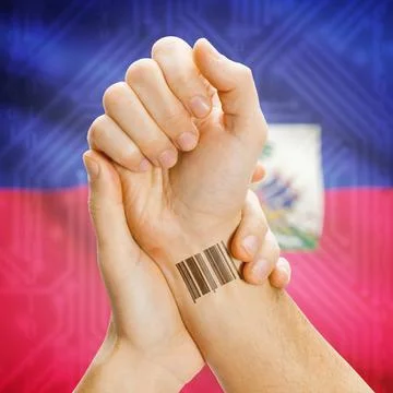 Barcode ID number on wrist and national flag on background - Haiti Barcode... Stock Photos