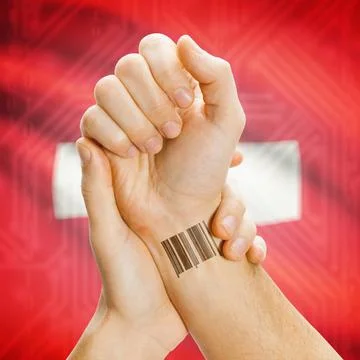 Barcode ID number on wrist and national flag on background - Switzerland B... Stock Photos