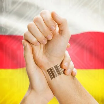 Barcode ID number on wrist and national flag on background - South Ossetia... Stock Photos