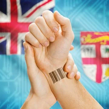 Barcode ID number on wrist and national flag on background - Fiji Barcode ... Stock Photos