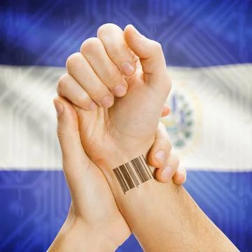 Barcode ID number on wrist and national flag on background - El Salvador B... Stock Photos