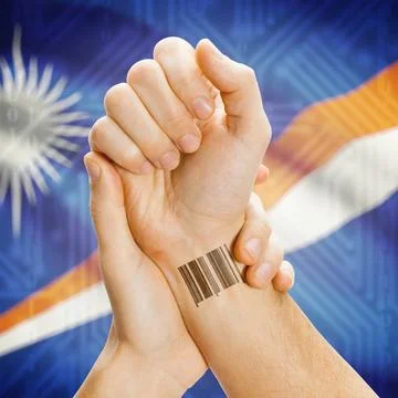 Barcode ID number on wrist and national flag on background - Marshall Isla... Stock Photos