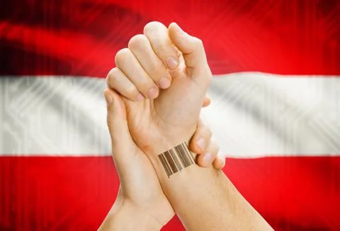 Barcode ID number on wrist of a human and national flag on background - Austr 库存照片