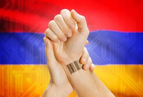 Barcode ID number on wrist of a human and national flag on background - Armen 스톡 사진