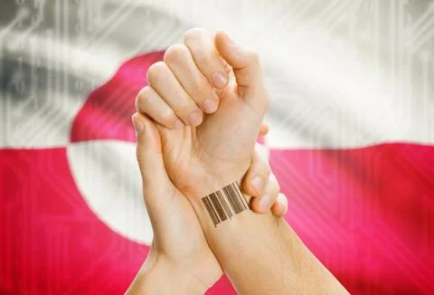 Barcode ID number on wrist of a human and national flag on background - Green Stock-Fotos