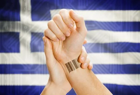 Barcode ID number on wrist of a human and national flag on background - Greec Stock-Fotos