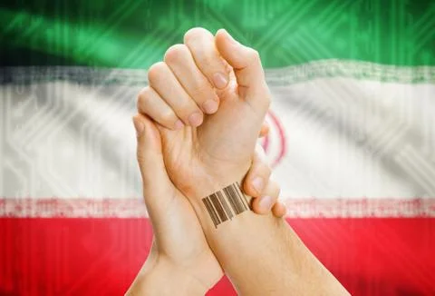 Barcode ID number on wrist of a human and national flag on background - Iran 스톡 사진