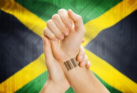 Barcode ID number on wrist of a human and national flag on background - Jamai Stock-Fotos