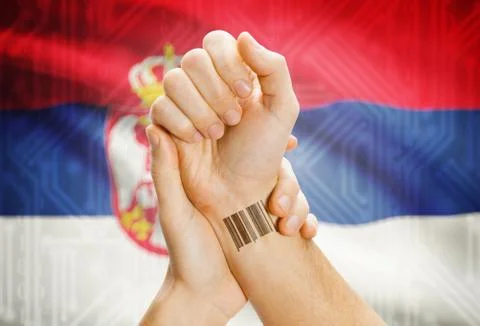 Barcode ID number on wrist of a human and national flag on background - Serbi Stock-Fotos