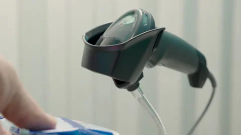 Barcode reader scans barcodes from product packages. 스톡 동영상 320588185
