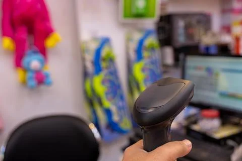 Barcode scanner with cashier screen in the background Stock-Fotos