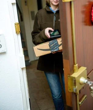 Barcode scanner device the cardboard parcel from Amazon Prime delivery one day Stock Photos