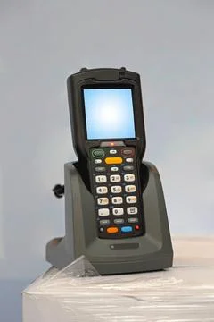 Barcode scanner Handheld laser barcode scanner reader at charger dock Copy... Stock-Fotos
