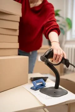 Barcode scanner scanning box at retail shop. service counter parcel processin Stock Photos