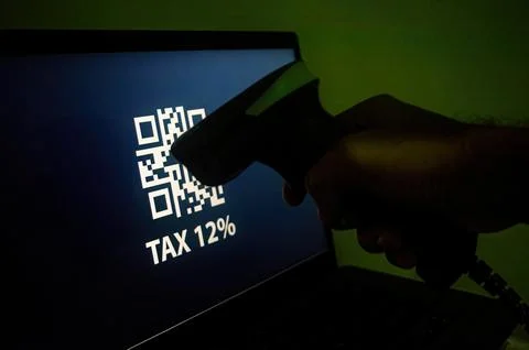 A barcode scanner is scanning a QR code displayed on a screen with the text.. Stock Photos