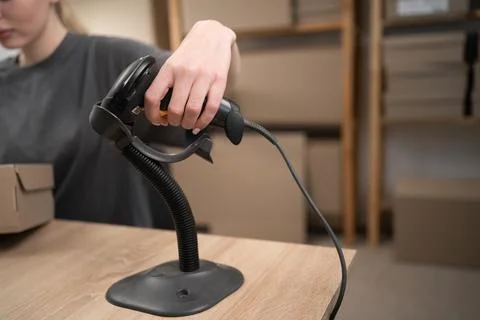 Barcode scanner at shipping counter and processing parcels for delivery Stock Photos