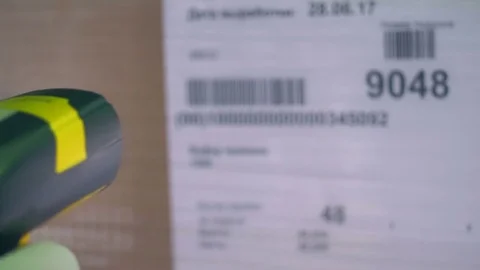 A barcode scanner used on a carton box sticker. Stock Footage 77970054
