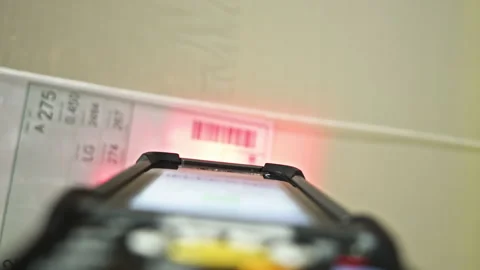 Barcode scanner using on cardboard box in warehouse close up pov Stock Footage 248647662