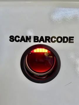 Barcode scanning lens camera mounted on a white surface with text instructions Stock Photos