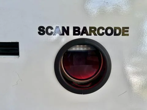 Barcode scanning lens camera mounted on a white surface with text instructions Stock Photos
