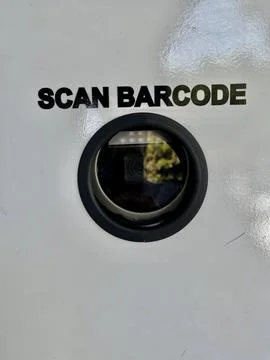 Barcode scanning lens camera mounted on a white surface with text instructions Stock Photos