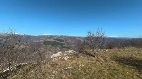 Bare branches frame a quiet hillside. Balkan, Eastern Europe, POV Vidéo 331814885