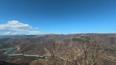 Bare branches frame a vast, rugged valley. Balkan, Eastern Europe, POV Video stock 331815450
