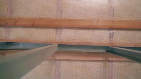 Bare ceiling without repair in a private house. The glass wool is covered with a Stock Footage 237759715
