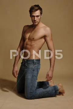 Bare-Chested Man In Jeans, Kneeling