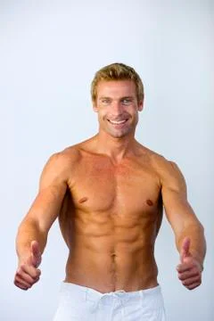 Bare-chested man thumbs up Foto stock
