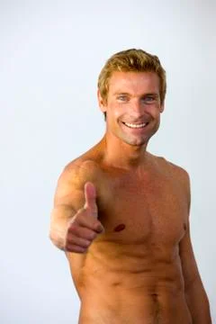 Bare-chested man thumbs up Stock Photos
