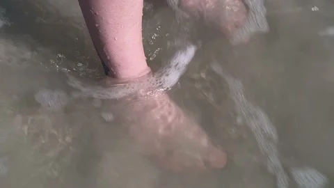 Bare feet ankle deep in the ocean Stock Footage 160125066