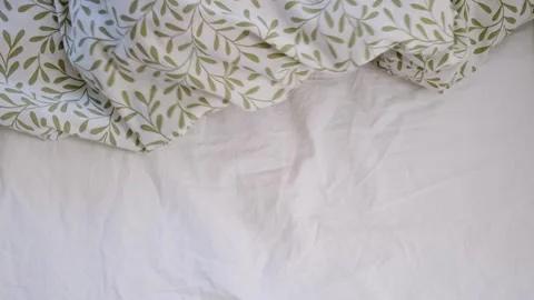 The bare feet of child hiding under the blanket after morning wake up. Sleeping Stock Footage 285612248